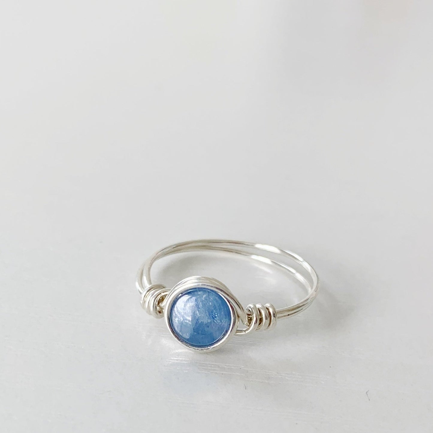 the brewster ring by mermaids and madeleines is a sterling silver wire wrapped ring with sterling silver wire. this ring is photographed on a white surface