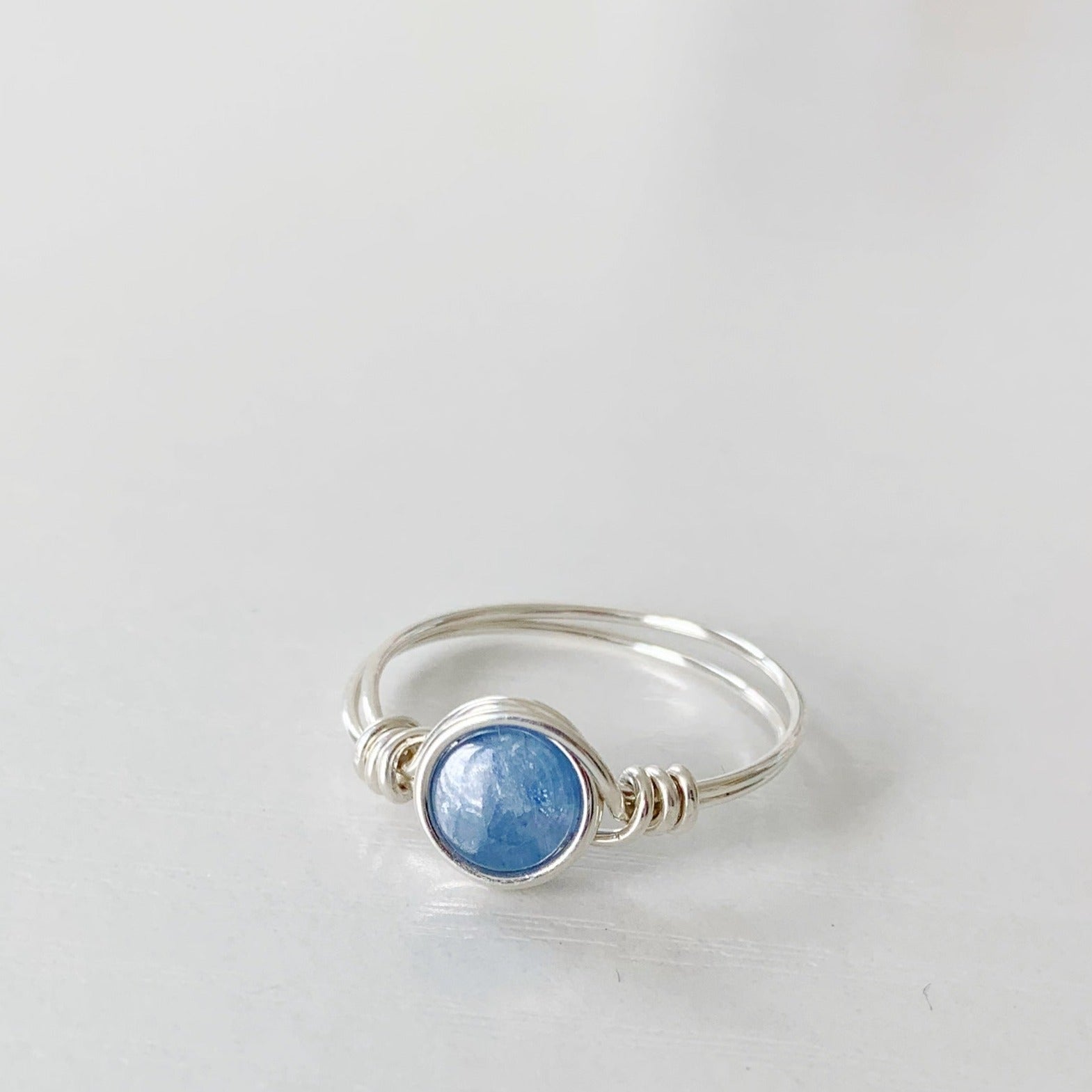 the brewster ring by mermaids and madeleines is a sterling silver wire wrapped ring with sterling silver wire. this ring is photographed on a white surface