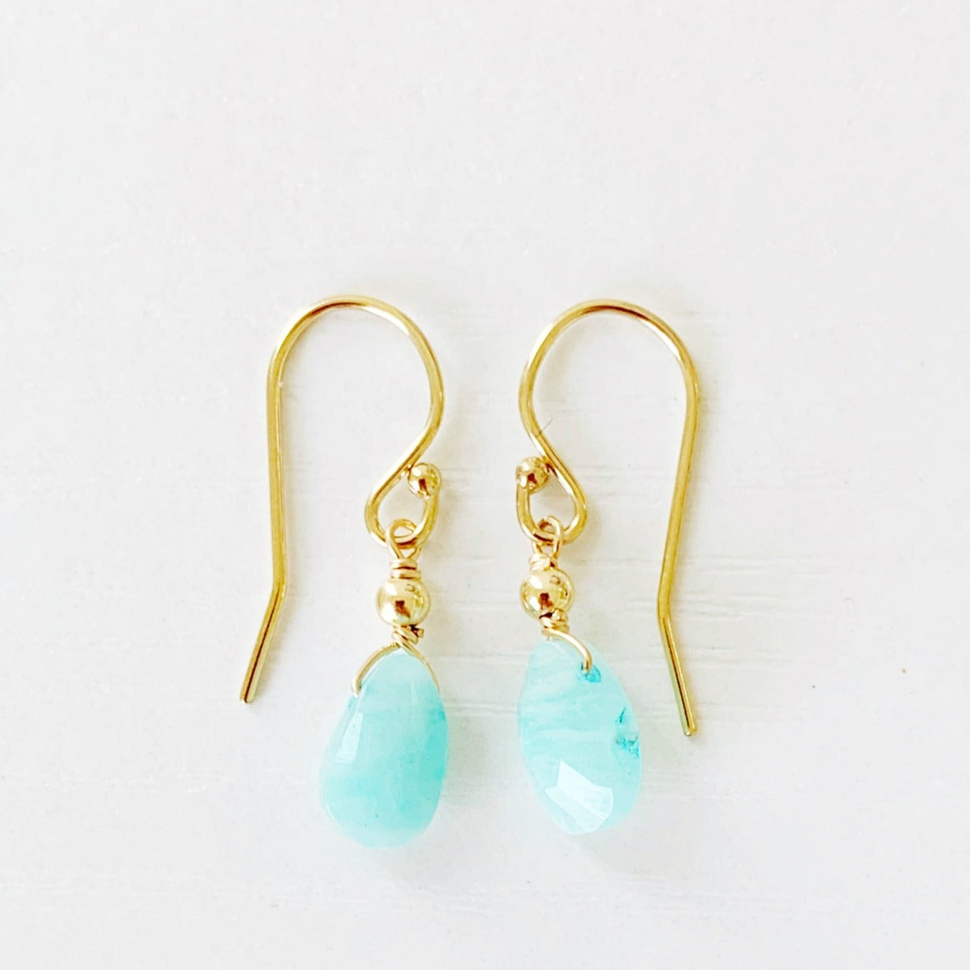 the captiva earring by mermaids and madeleines are dainty  earrings with small faceted amazonite briolettes with 14k gold filled findings. this pari is photographed on a white surface