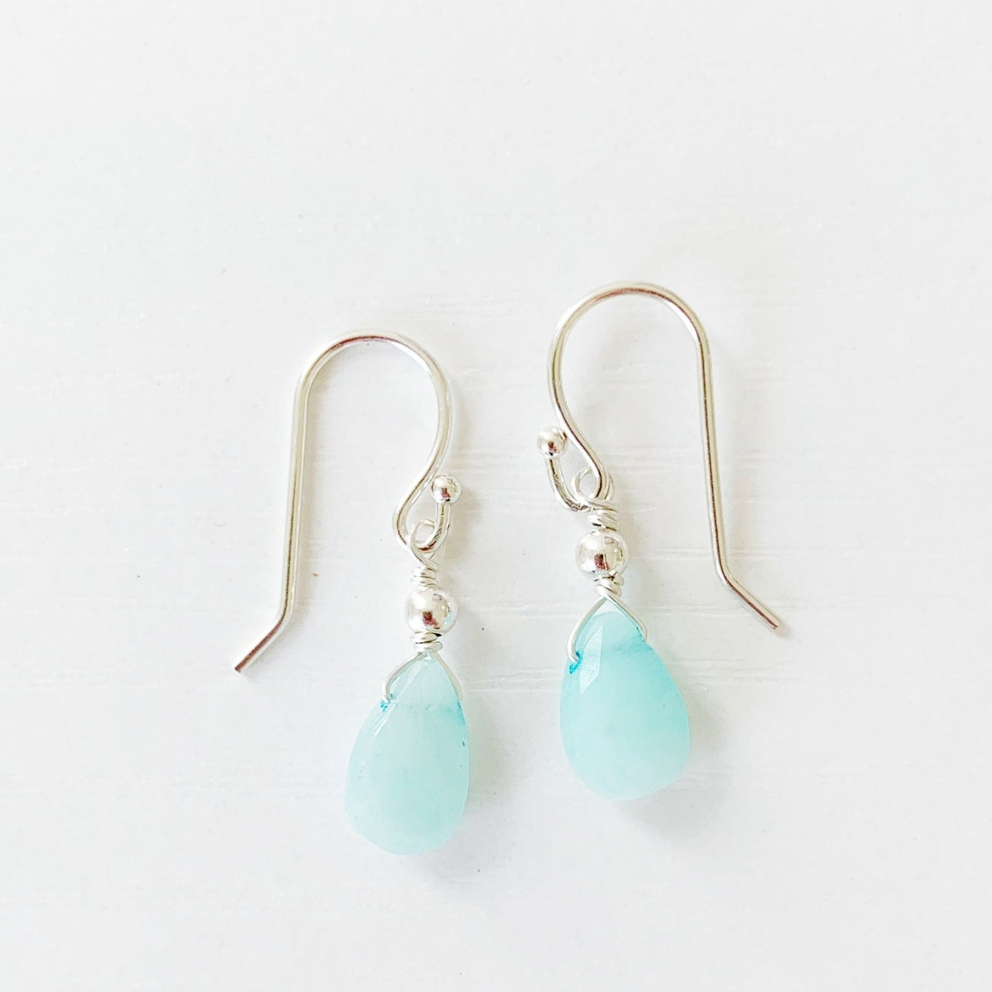 the captiva earrings by mermaids and madeleines are created with amazonite briolettes and sterling silver findings. this pair is photographed on a white surface