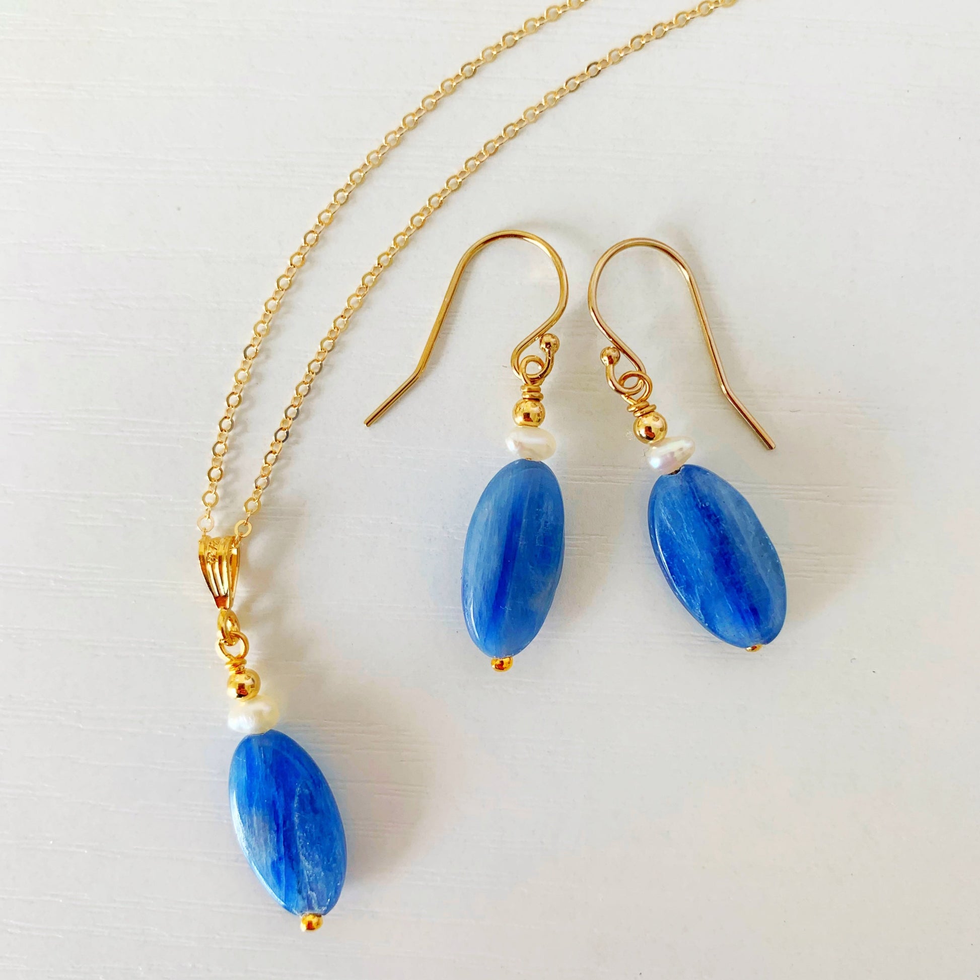 image of a brewster necklace and matching pair of earrings all photographed flat on a white surface