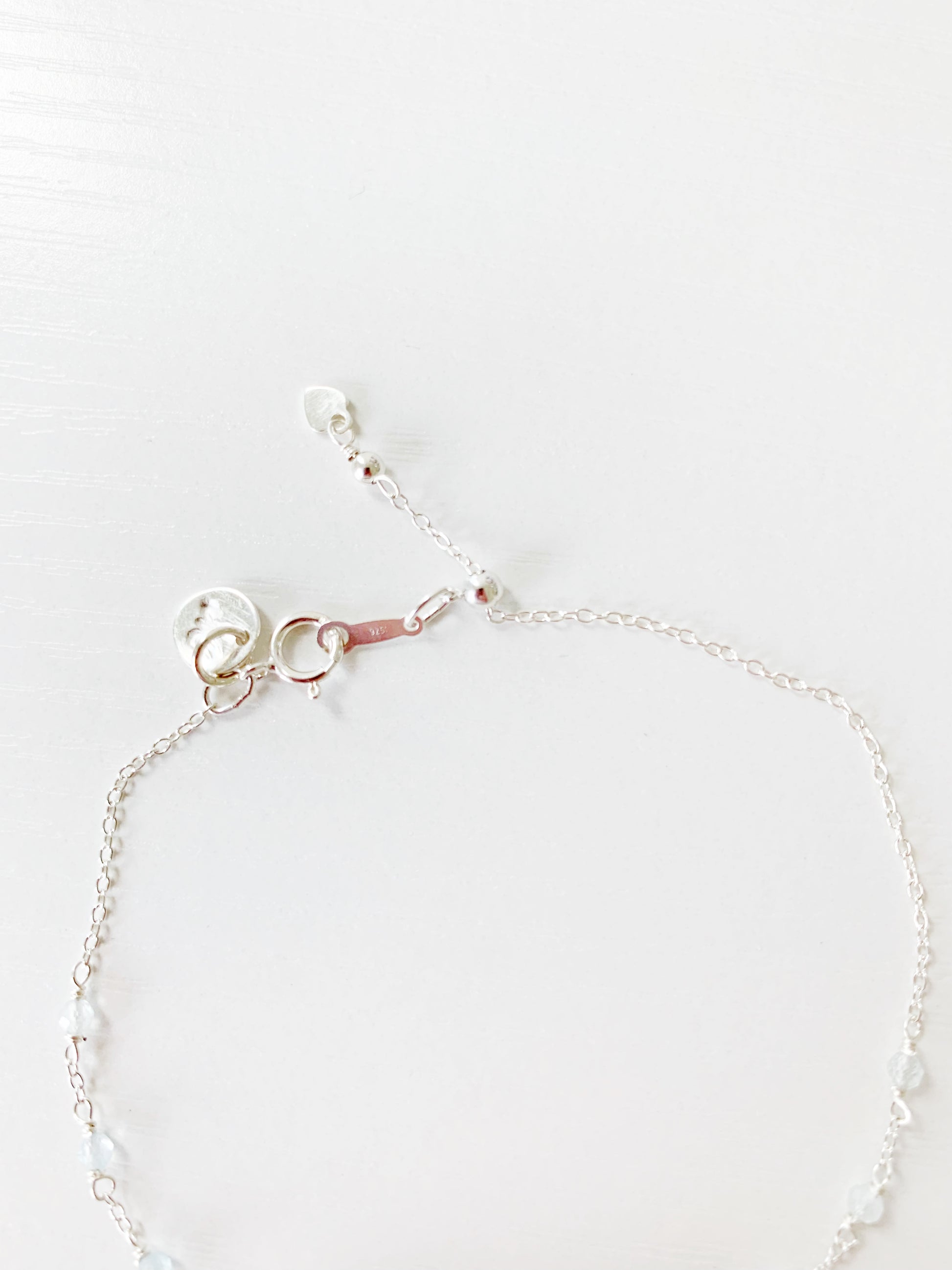 this image is the back half of the Truro bracelet showing the sterling silver chain, findings and slide clasp. this piece is photographed on a white surface