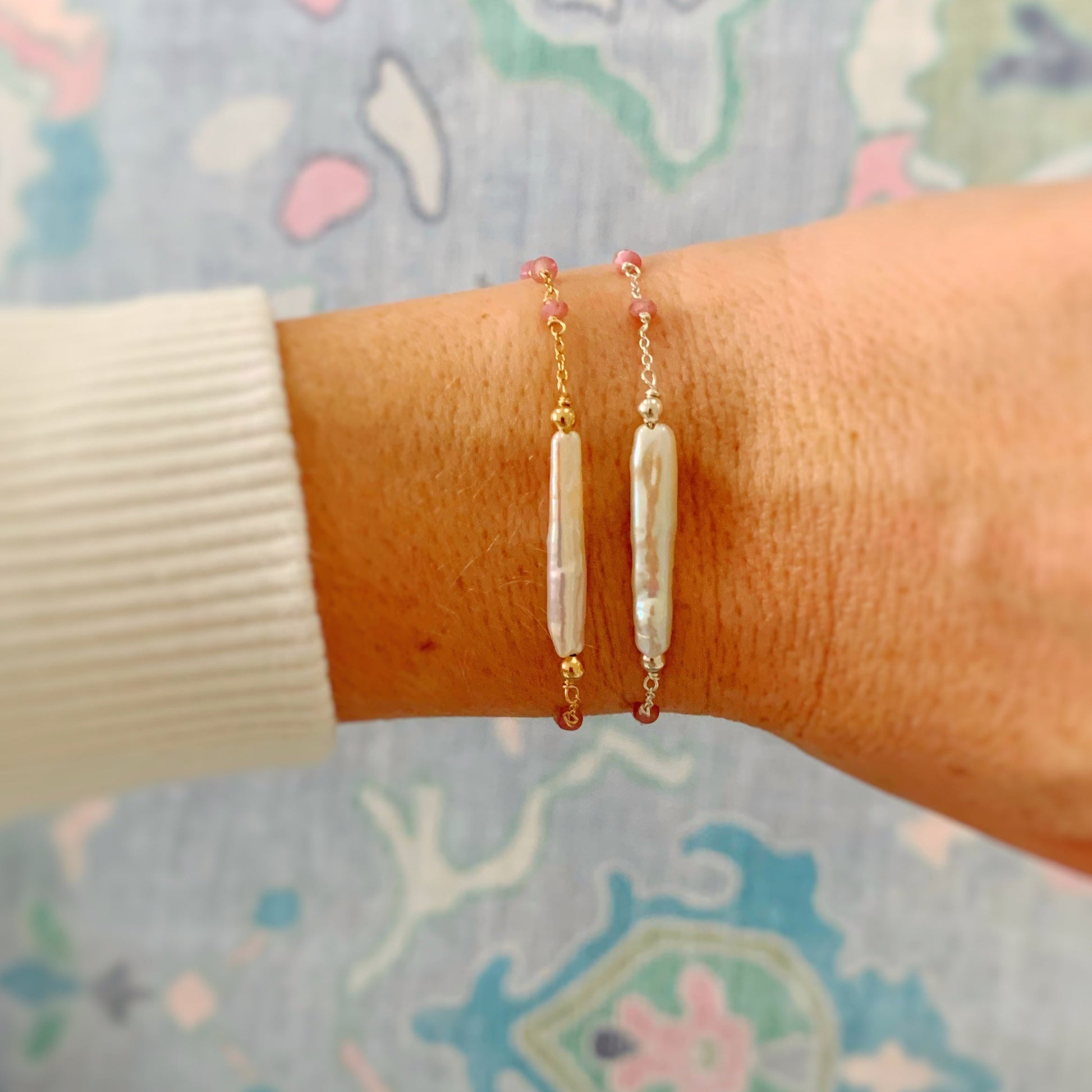 pink azalea bracelets in 14k gold filled and sterling silver are shown in this photograph being worn on a wrist. 